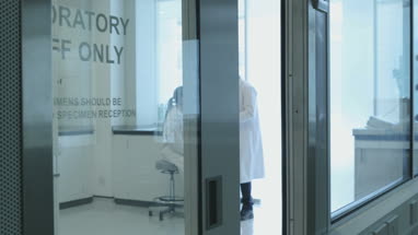 Female scientist discussing results of experiment with male colleague