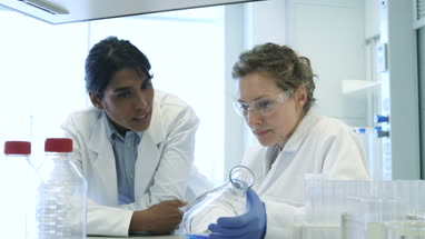 Close-up of two female scientists discussing results of experiment