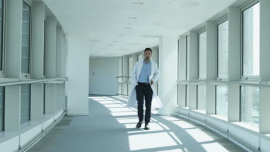 Medical professional checking smartphone on way to meeting