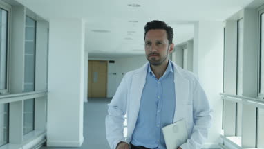 Medical professional checking smartphone on way to meeting