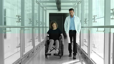 Woman in wheelchair talking with medical professional