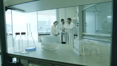 Team of scientists discussing experiment data on digital tablet