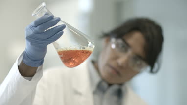 Female scientist analyzing experiment