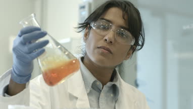 Female scientist analyzing experiment