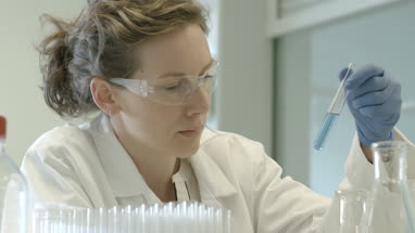 Female scientist analyzing test tube sample