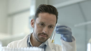 Male scientist looking at test tube in a laboratory