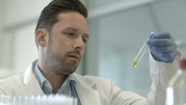Male scientist looking at test tube in a laboratory