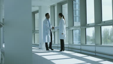 Two medical professionals shaking hands