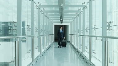 Businessman walking through airport terminal