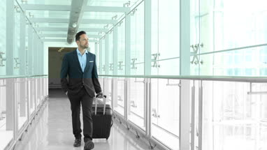 Businessman walking through airport terminal