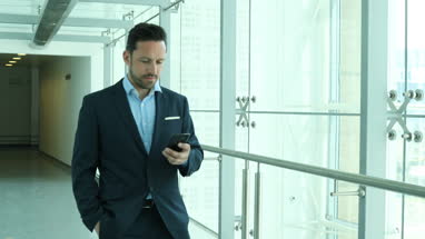 Businessman using smartphone on his commute