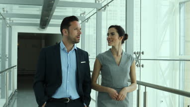 Business colleagues walking through office corridor