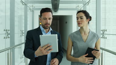 Business colleagues looking at digital tablet together
