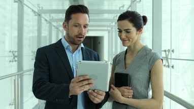 Business colleagues looking at digital tablet together