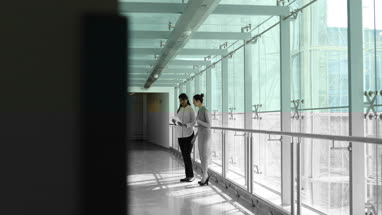 Business colleagues looking at digital tablet on way to a presentation