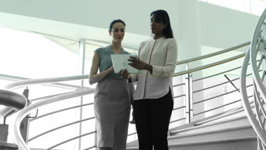 Business colleagues looking at digital tablet together