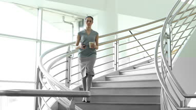 Businesswoman using smartphone app on her way to work