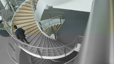 Overhead shot of business executives passing on staircase