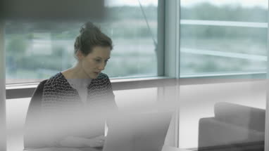 Female executive working in office on laptop