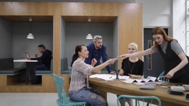 Group of designers looking at samples in a meeting