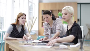 Female designers looking at samples in a meeting