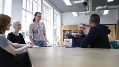 Creative designers celebrating success in a meeting