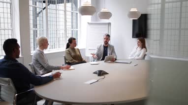 Male business executive leading a meeting