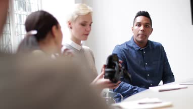 Designer presenting virtual reality headset in a meeting