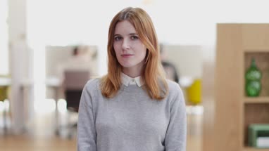 Portrait of female entrepreneur in a modern shared workplace