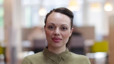 Portrait of female entrepreneur in a modern shared workplace