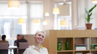 Female entrepreneur thinking in a modern shared workplace