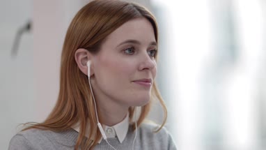 Female listening to audio with headphones