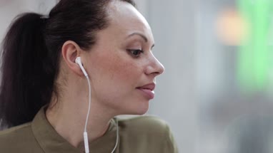 Female listening to audio with headphones