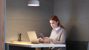 Businesswoman working late at night in office alone