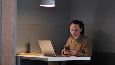 Businesswoman working late at night in office alone