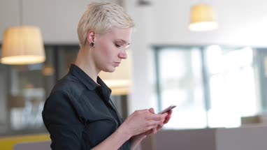 Entrepreneur using smartphone in an office