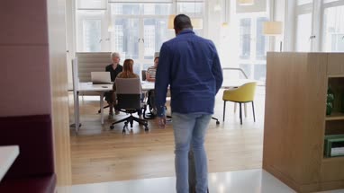 Entrepreneur skateboarding in to an office meeting