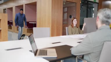 Entrepreneur skateboarding in to an office meeting