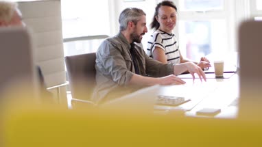 Coworkers looking at a laptop together