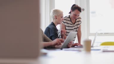 Manager training new employee in office