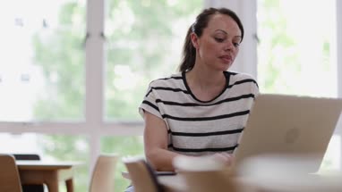 Businesswoman in office working on laptop