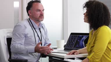 Male Medical Doctor explaining xray results to patient