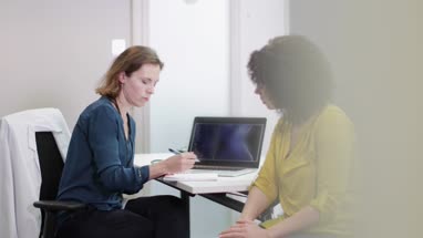 Female Medical Doctor listening to patient symptoms