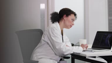 Female Medical Doctor looking at xray results on laptop