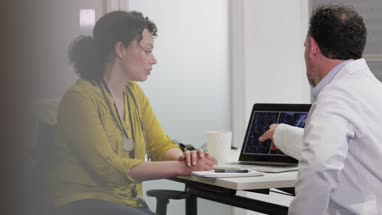 Medical Doctors discussing patient treatment together