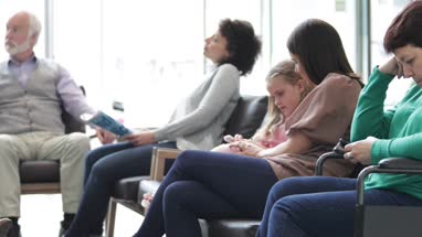 Patients waiting in a crowded hospital waiting room 