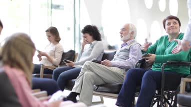 Disabled woman talking with Doctor in waiting room