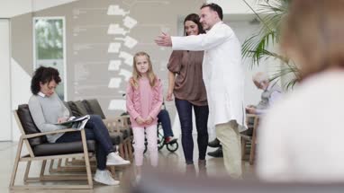 Medical Doctor taking Mother with Daughter through to treatment