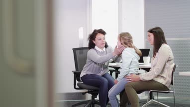 Female Medical Doctor checking a child's neck glands