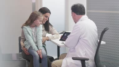 Family Doctor showing Mother and Daughter test results